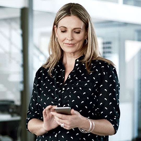 woman looking into her mobile