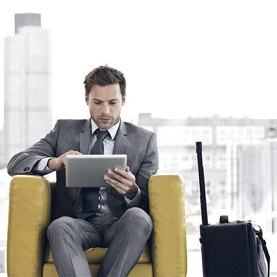 man and woman working on laptop