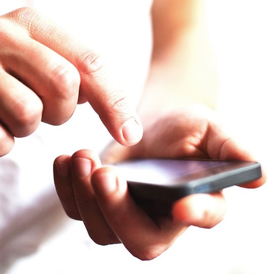 close up of a hand typing on a smartphone