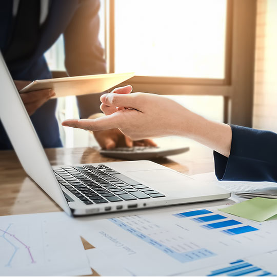 hands pointing a laptop